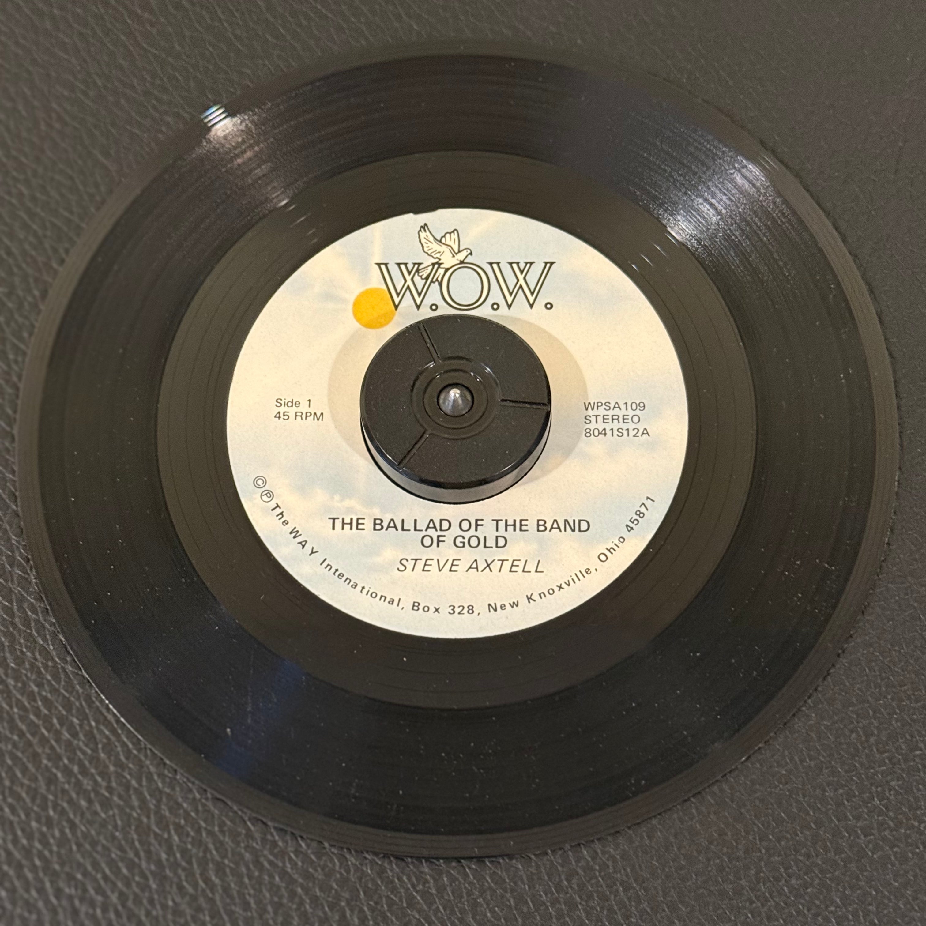 7" vinyl record by Steve Axtell featuring "The Ballad Of The Band Of Gold/Seated In The Heavenlies", released on W.O.W. (WPSA 109), in VG+ (Very Good Plus) condition, classic analog collectable for turntable playback. Pic Sleeve Included!