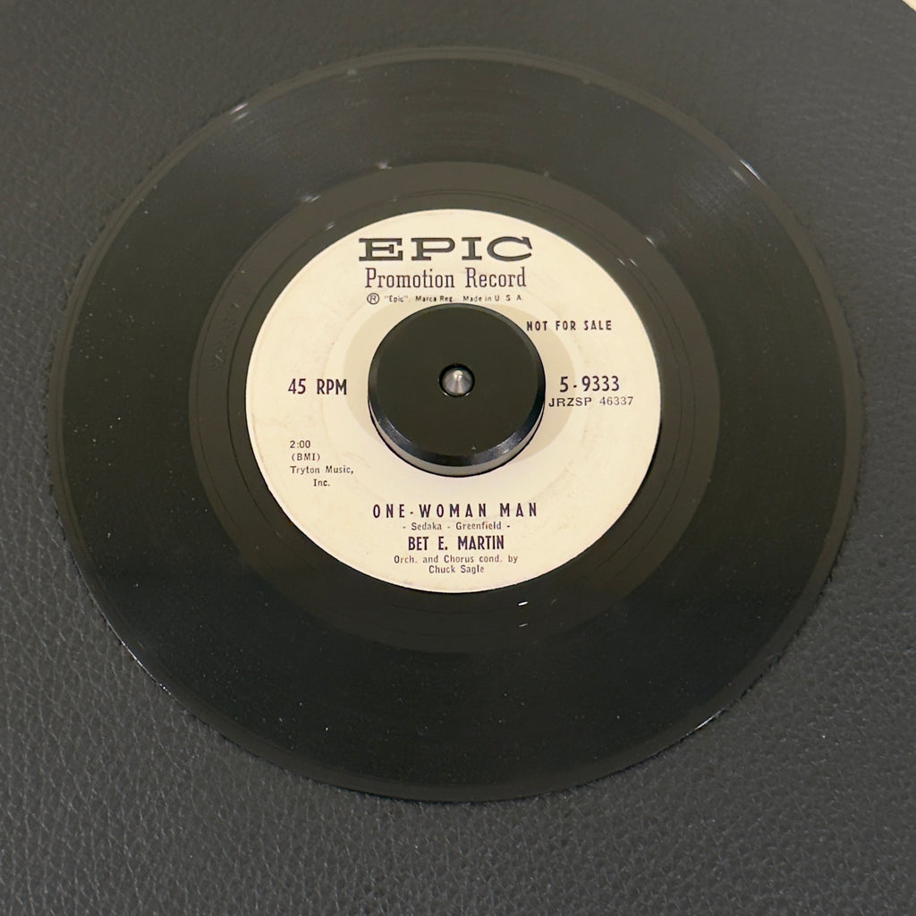 7" vinyl record by Bet E. Martin featuring "One-Woman Man/Maybe You'll Be There", released on Epic (5-9333), in VG (Very Good) condition, classic analog collectable for turntable playback. Vintage 1959 Rock Promo in generic white sleeve.