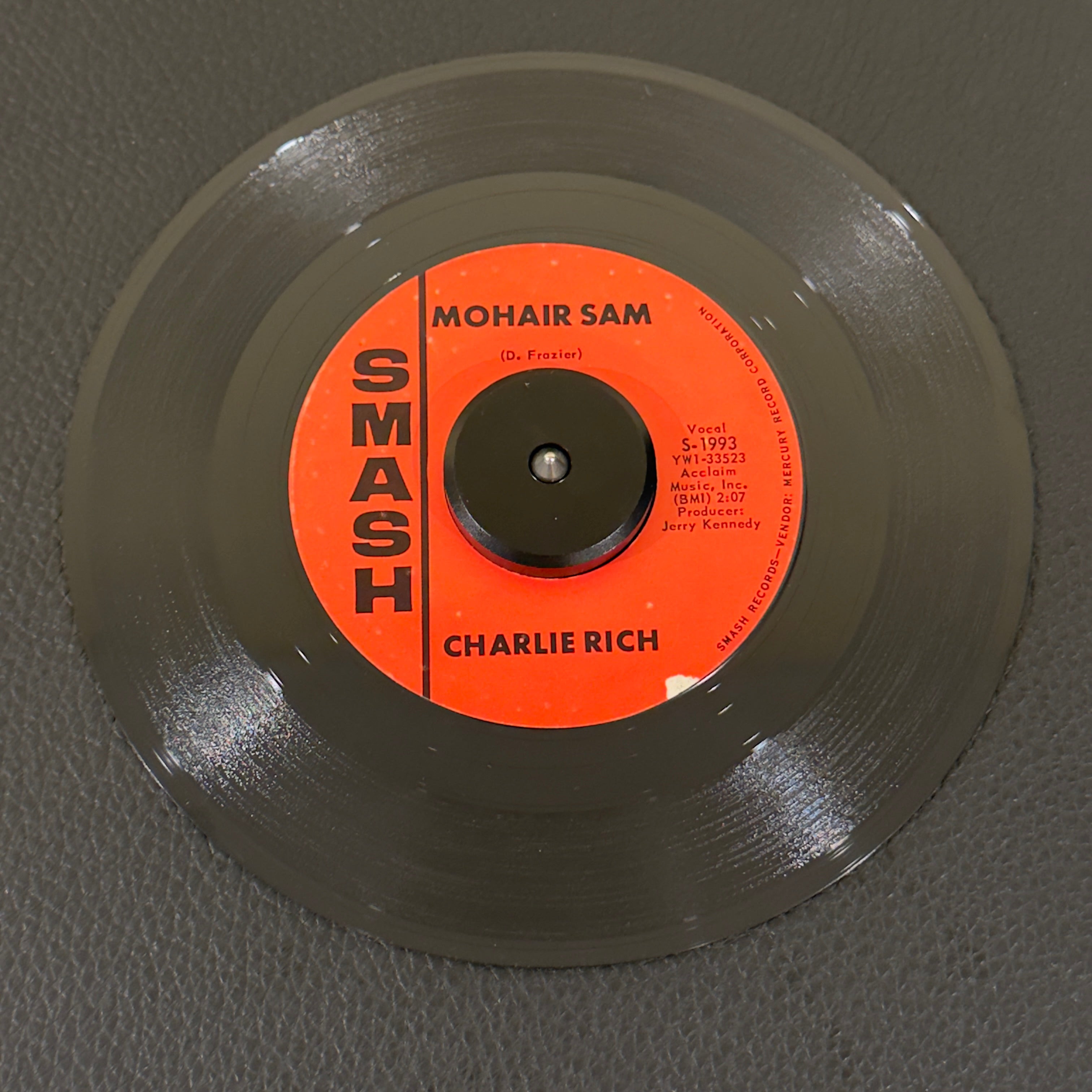 7" vinyl record by Charlie Rich featuring "Mohair Sam/I Washed My Hands In Muddy Water", released on Smash Records (S-1993), in VG (Very Good) condition, classic analog collectable for turntable playback. The "Silver Fox" performing his smash hit!  Includes original Smash Records sleeve.