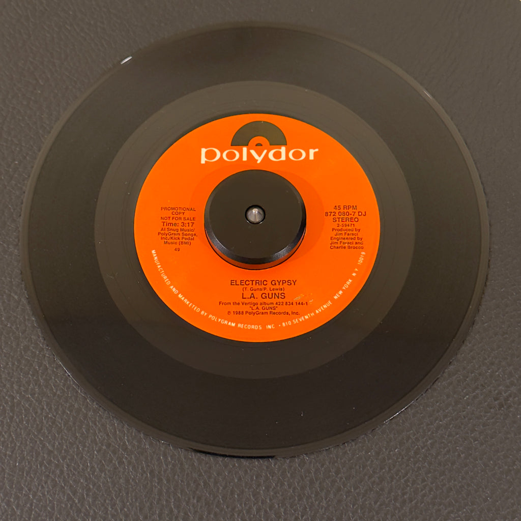 7" vinyl record by L.A. Guns featuring "Electric Gypsy", released on Polydor (872-080-7 DJ), in NM (Near Mint) condition, classic analog collectable for turntable playback. Rare 1980's Hair Metal promo in original Polydor sleeve!!