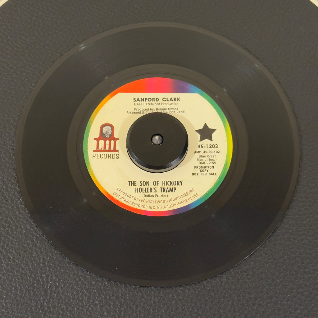 7" vinyl record by Sanford Clark featuring "The Son Of Hickory Hollers Tramp/The Black Widow Spider", released on LHI Records (45-1203), in VG+ (Very Good Plus) condition, classic analog collectable for turntable playback. Promotional copy! Includes the highly sought after cult classic "The Black Widow Spider".